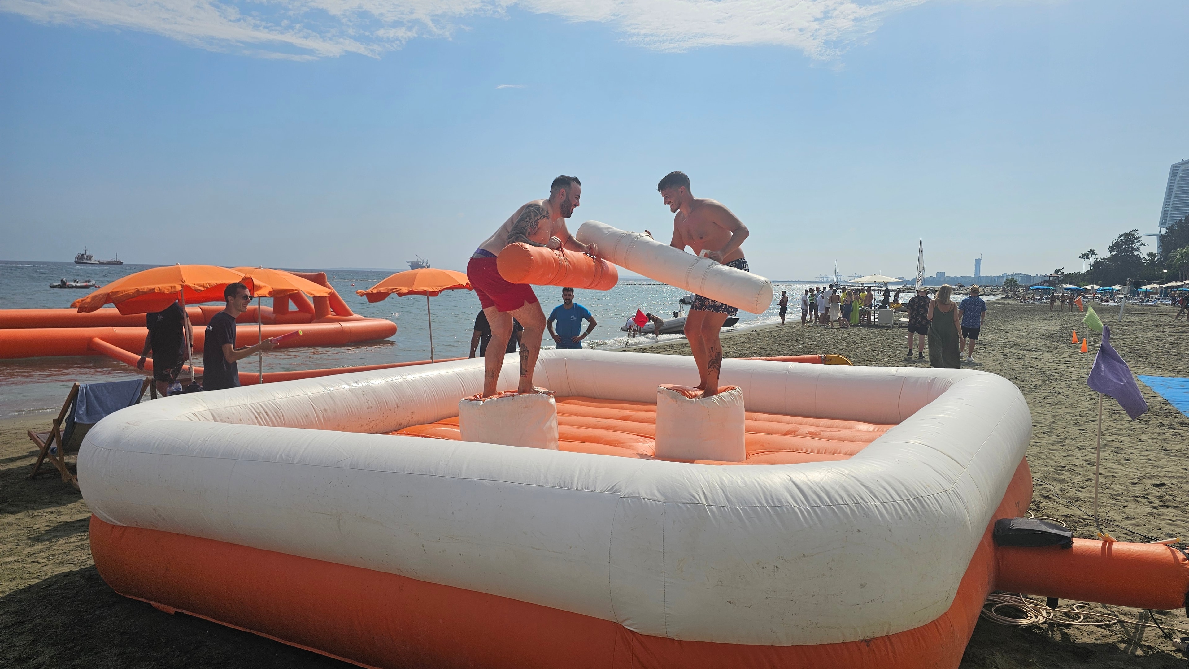 Group enjoying a beach inflatable team activity