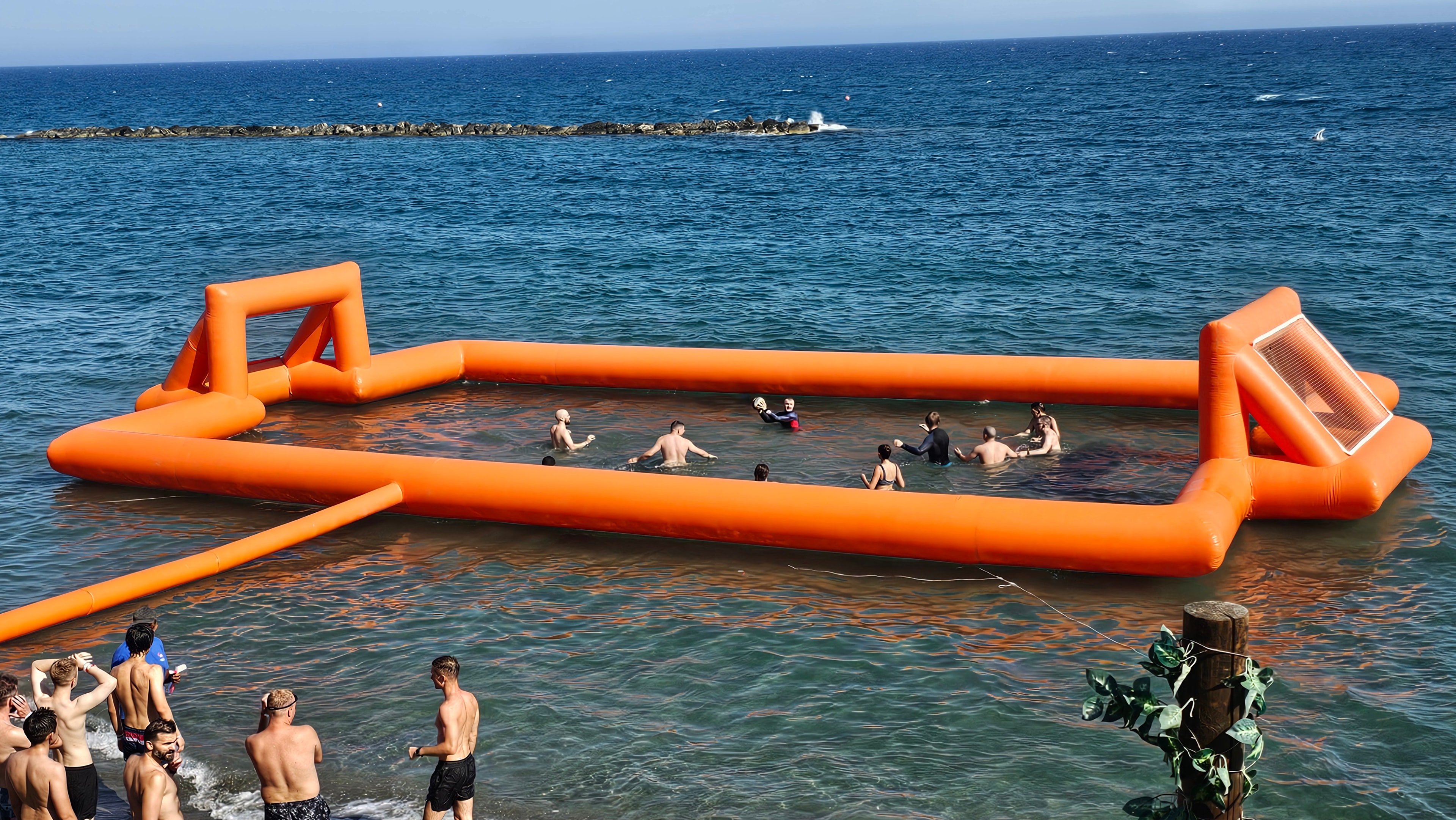 Participants taking part in a beach inflatable relay challenge
